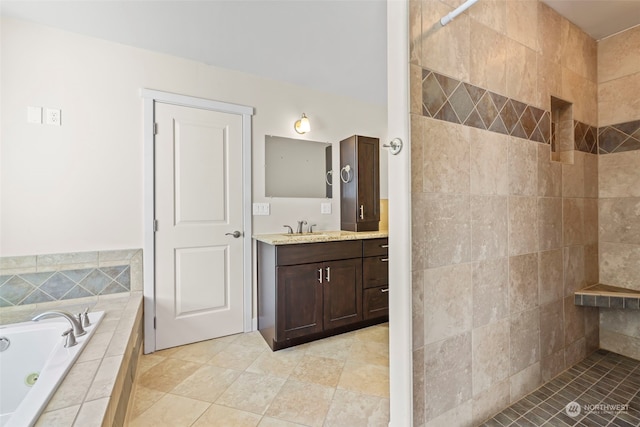 bathroom featuring tiled shower, a garden tub, and vanity