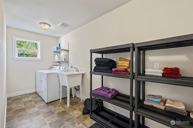 laundry area featuring laundry area, washing machine and dryer, visible vents, and baseboards