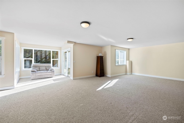 unfurnished room featuring light carpet