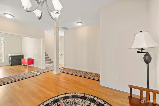 entryway with hardwood / wood-style flooring and an inviting chandelier