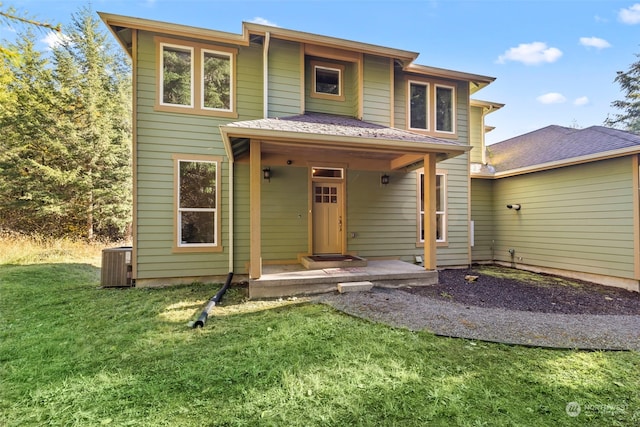 view of front facade with central AC unit and a front yard