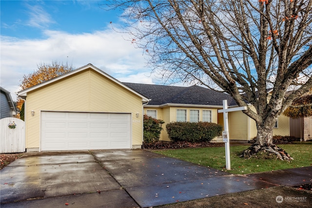 ranch-style home with a front yard and a garage