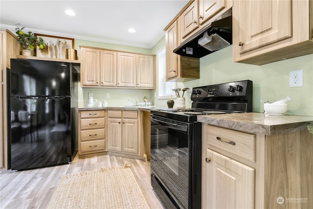 kitchen with light brown cabinets, light hardwood / wood-style flooring, black appliances, and ornamental molding