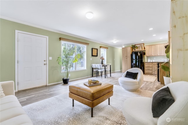 living room featuring light wood-type flooring and crown molding