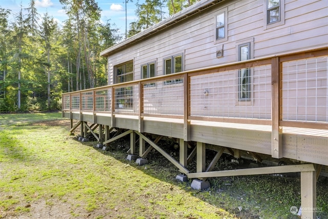 view of home's exterior with a yard and a wooden deck