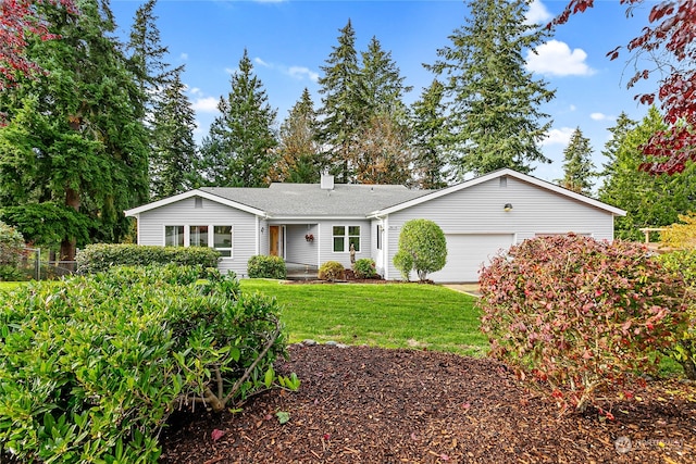 ranch-style house featuring a garage and a front yard