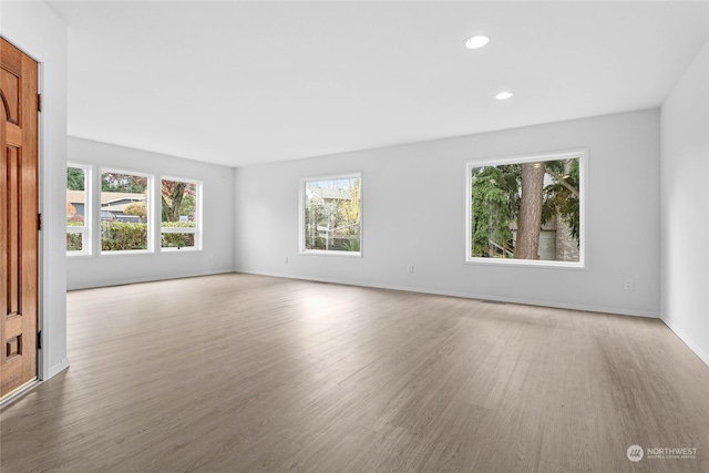 unfurnished room with hardwood / wood-style floors