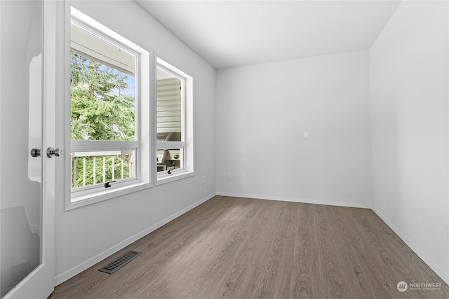 unfurnished room with hardwood / wood-style floors