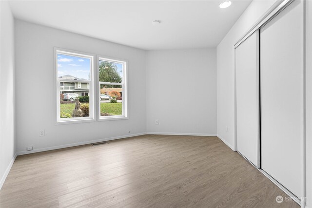 unfurnished bedroom with light wood-type flooring