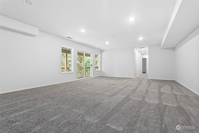 unfurnished living room with light colored carpet