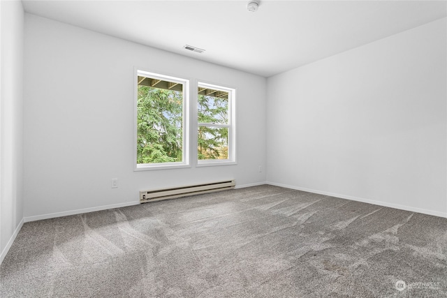 carpeted spare room featuring a baseboard radiator