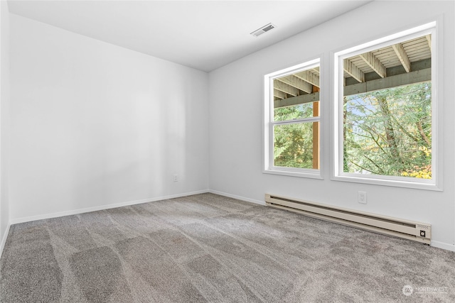 carpeted empty room featuring baseboard heating