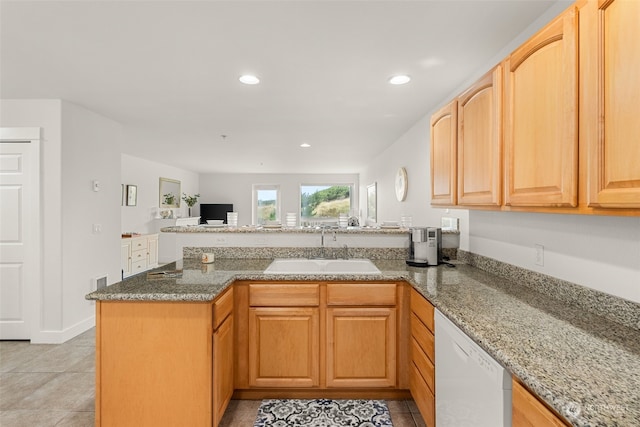 kitchen with dishwasher, kitchen peninsula, sink, and stone countertops