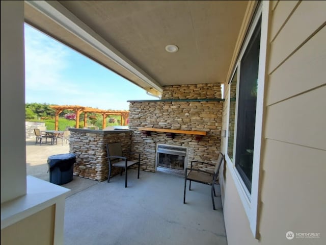 view of patio with an outdoor stone fireplace