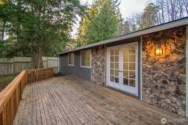 deck featuring french doors and fence