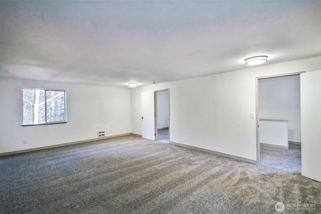 carpeted spare room featuring baseboards