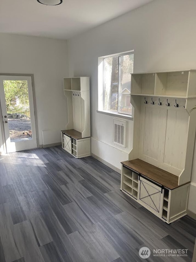 mudroom featuring visible vents, baseboards, and dark wood-type flooring