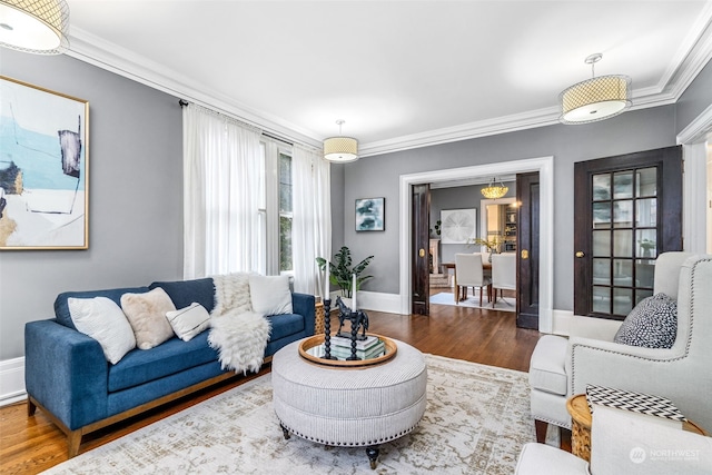 living room with hardwood / wood-style floors and crown molding