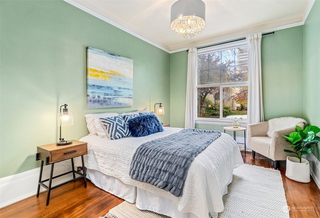 bedroom featuring a chandelier, hardwood / wood-style flooring, and crown molding