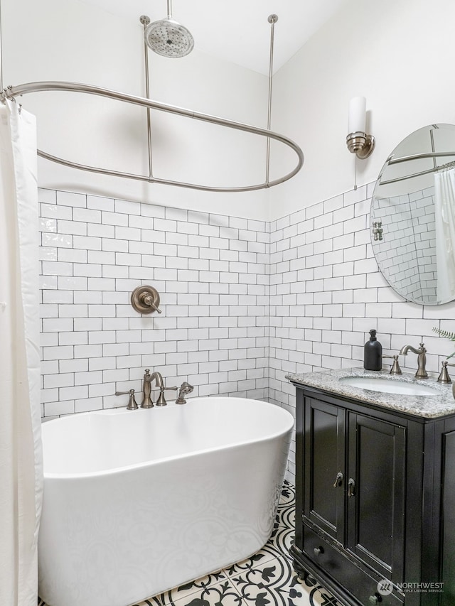 bathroom featuring independent shower and bath, tile patterned flooring, vanity, and tile walls