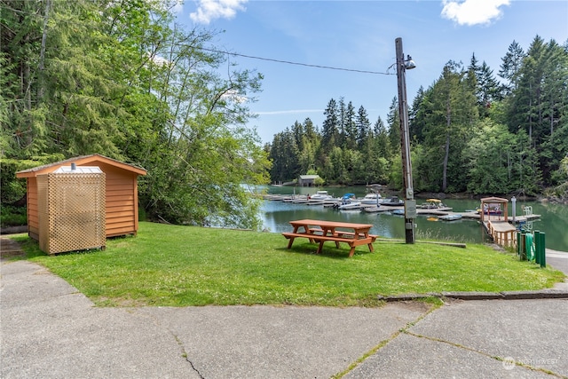 view of yard featuring a storage unit and a water view