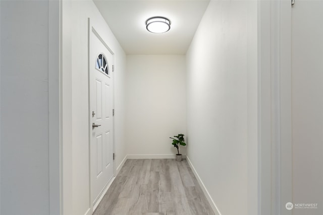 corridor with light hardwood / wood-style flooring