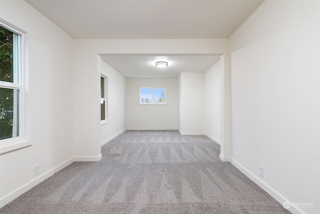 unfurnished room with light colored carpet