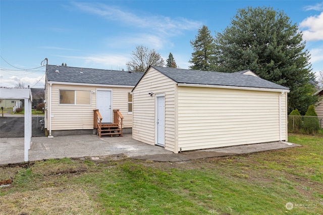 back of house featuring a lawn and a patio