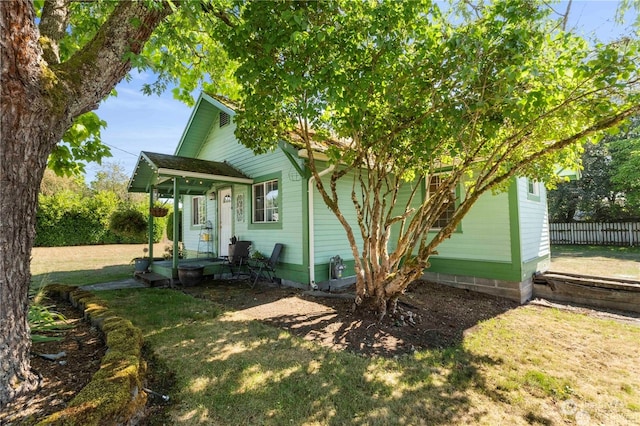 view of side of property with a lawn