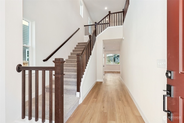 interior space with light hardwood / wood-style floors and a high ceiling