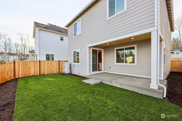 back of property featuring a lawn and a patio area