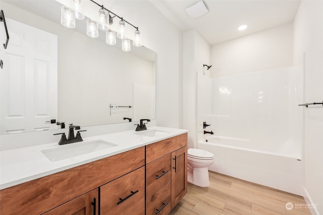 full bathroom with vanity, shower / bathtub combination, toilet, and wood-type flooring