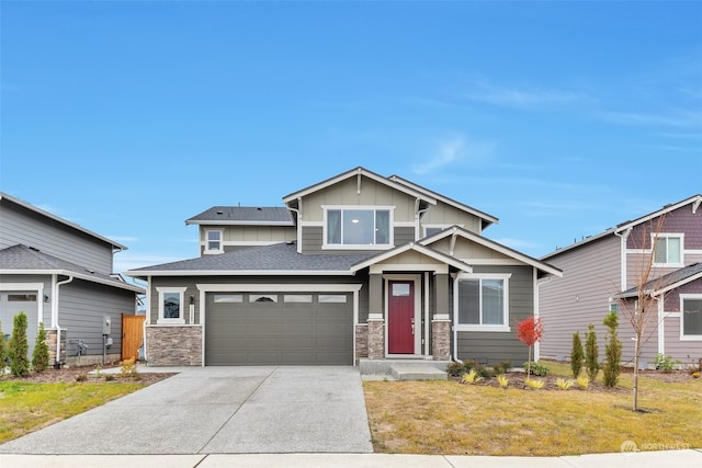 craftsman house with a front lawn and a garage