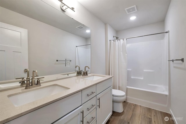 13307 Pines Ln E, Puyallup, WA 98374 - bathroom with shower / tub combo with curtain, double vanity, toilet, and wood finished floors