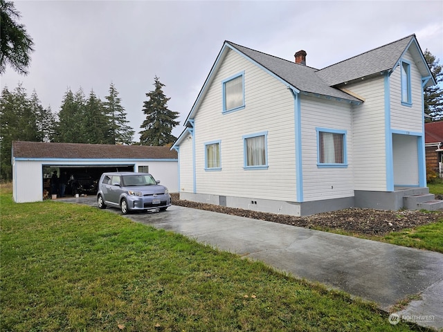 view of home's exterior featuring a lawn and a garage