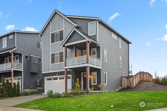 view of front of property featuring a front lawn, a balcony, and a garage