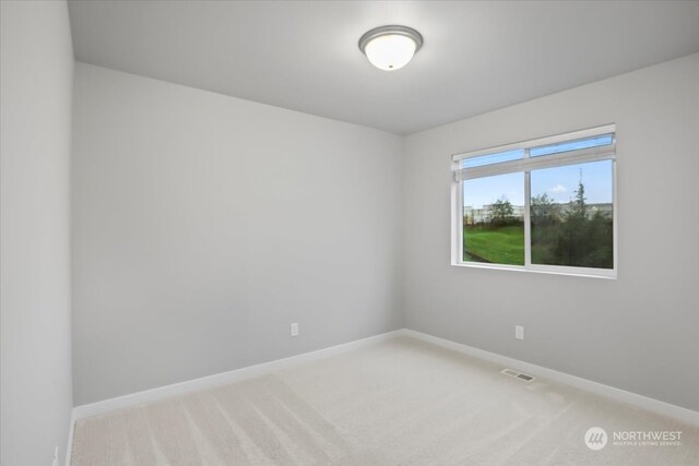 empty room with light colored carpet