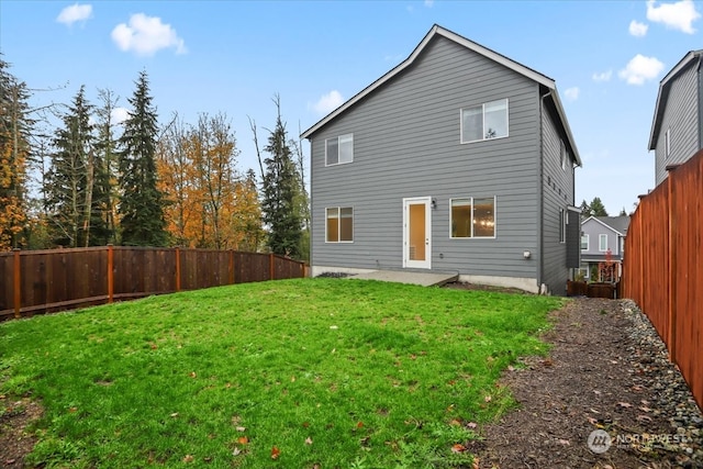 back of property with a lawn and a patio