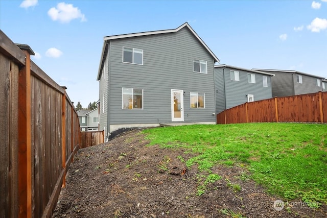 rear view of property with a yard