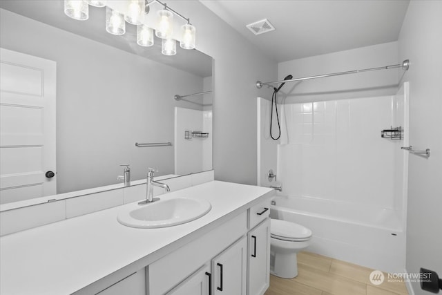 full bathroom with vanity, hardwood / wood-style flooring, toilet, and bathtub / shower combination