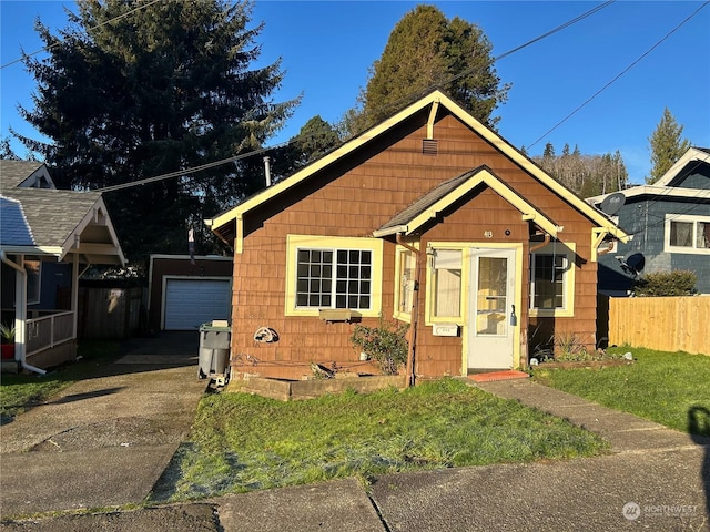 view of front facade featuring an outbuilding, a garage, and a front yard