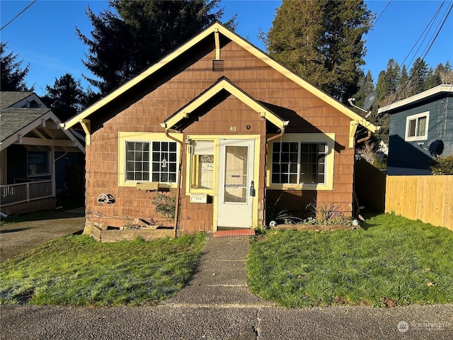 bungalow-style house with an outdoor structure and a front yard