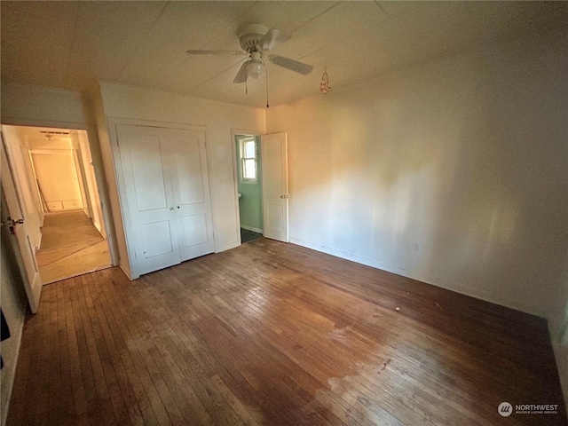 unfurnished bedroom with ceiling fan, hardwood / wood-style floors, and a closet