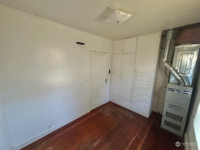 unfurnished bedroom featuring dark hardwood / wood-style flooring and a closet