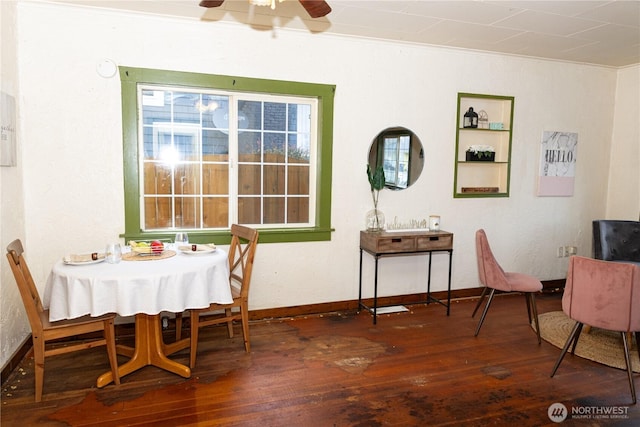 dining area featuring baseboards, dark wood-type flooring, ceiling fan, and ornamental molding