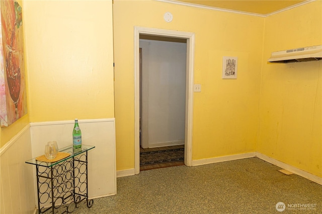 hallway with baseboards and ornamental molding