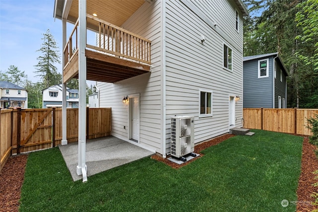 view of side of property featuring a patio area and a lawn