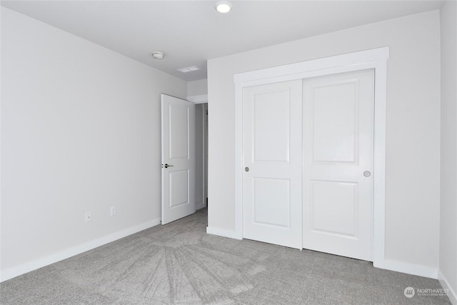 unfurnished bedroom featuring carpet and a closet