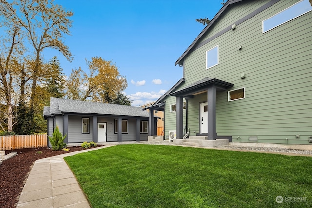 view of front of home featuring crawl space, roof with shingles, a front lawn, and fence