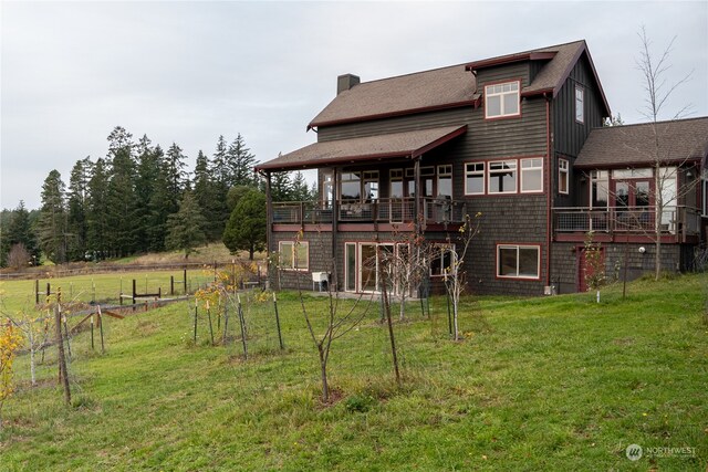 rear view of house featuring a wooden deck